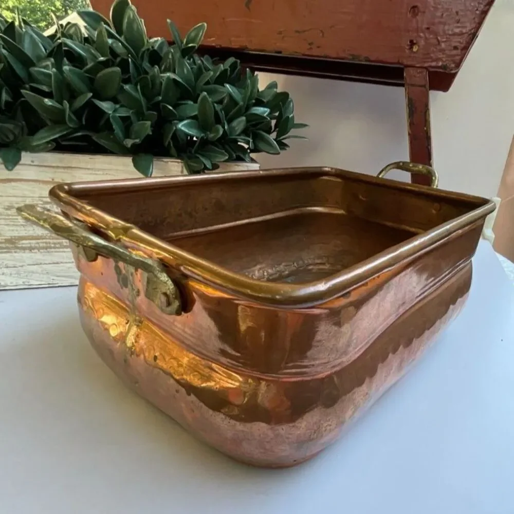 Antique hand-worked copper vessel visible dovetailed/soldered seam, hammered